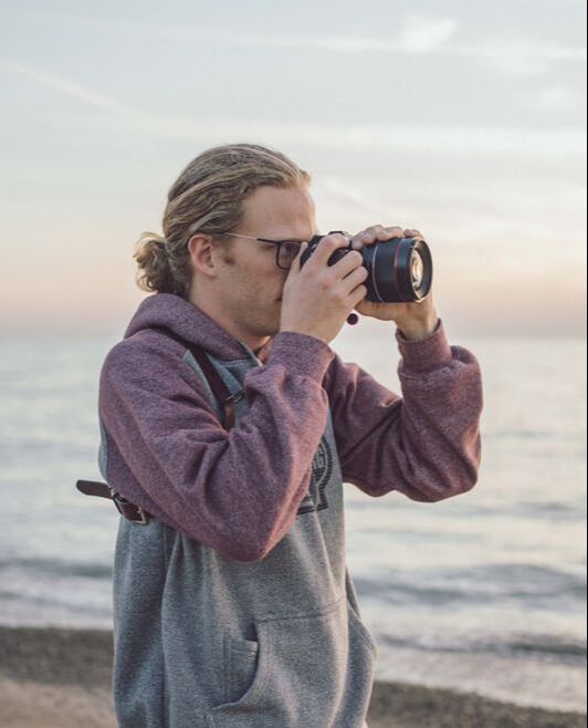 Jacob Medler on a beach taking photos