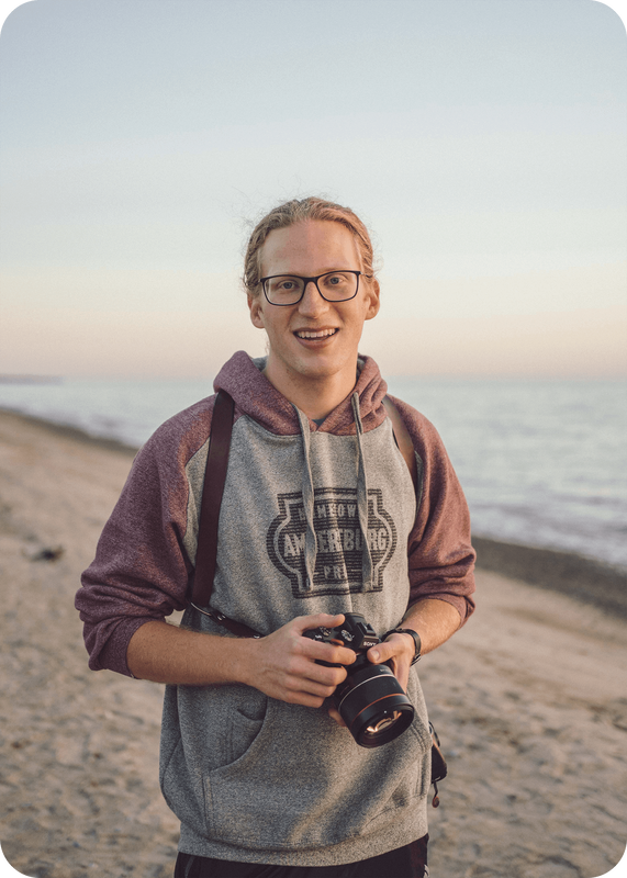 Jacob Medler with camera on beach
